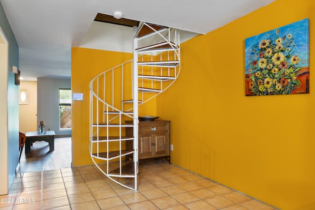 stairway featuring tile patterned floors