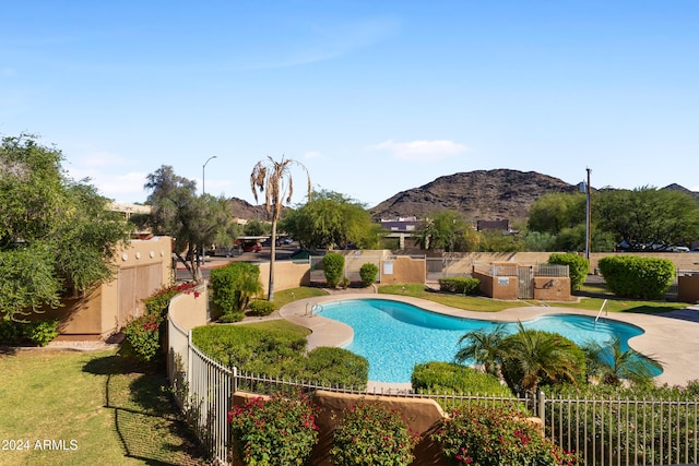 view of swimming pool featuring a mountain view and a patio