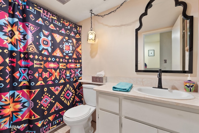 bathroom featuring toilet and vanity