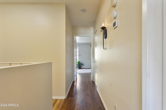 hallway with dark hardwood / wood-style flooring