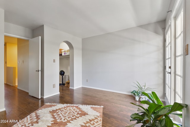 spare room with dark wood-type flooring