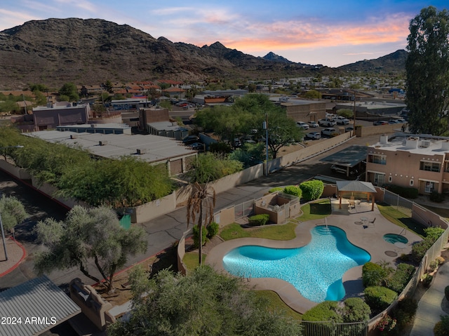 aerial view at dusk featuring a mountain view