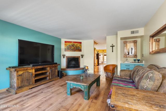 living room with hardwood / wood-style flooring and sink