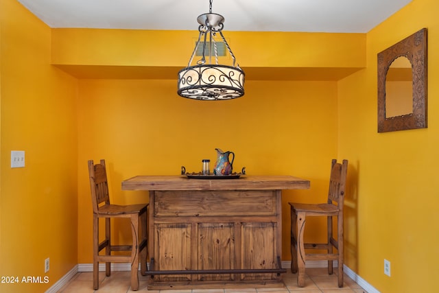 bar featuring pendant lighting and light tile patterned floors