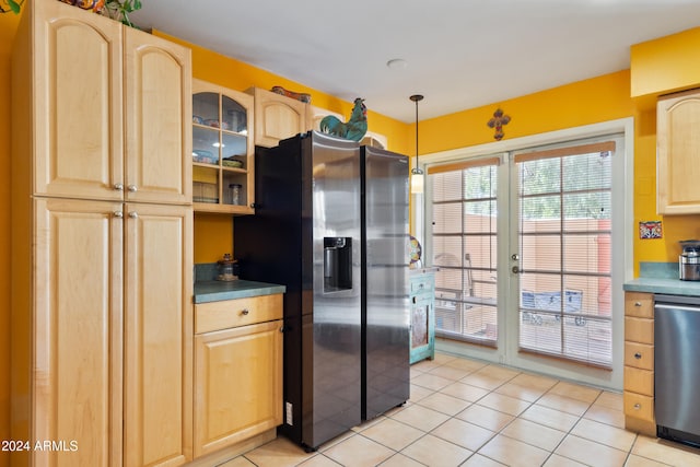 kitchen featuring black fridge, stainless steel dishwasher, light tile patterned flooring, pendant lighting, and light brown cabinetry