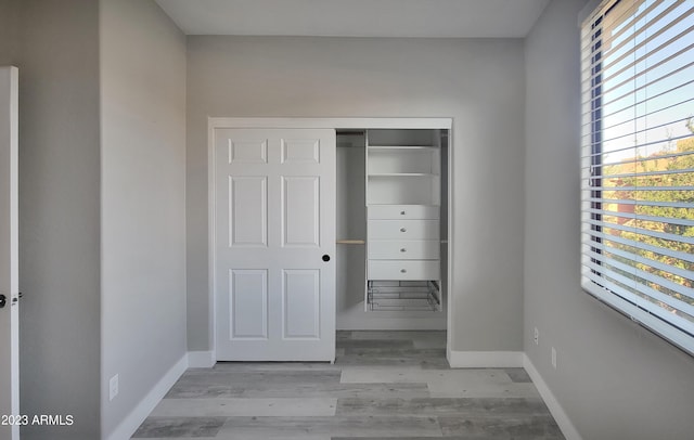9551 E Redfield Rd Unit 1061, Scottsdale, AZ 85260 - unfurnished bedroom with baseboards, wood finished floors, and a closet