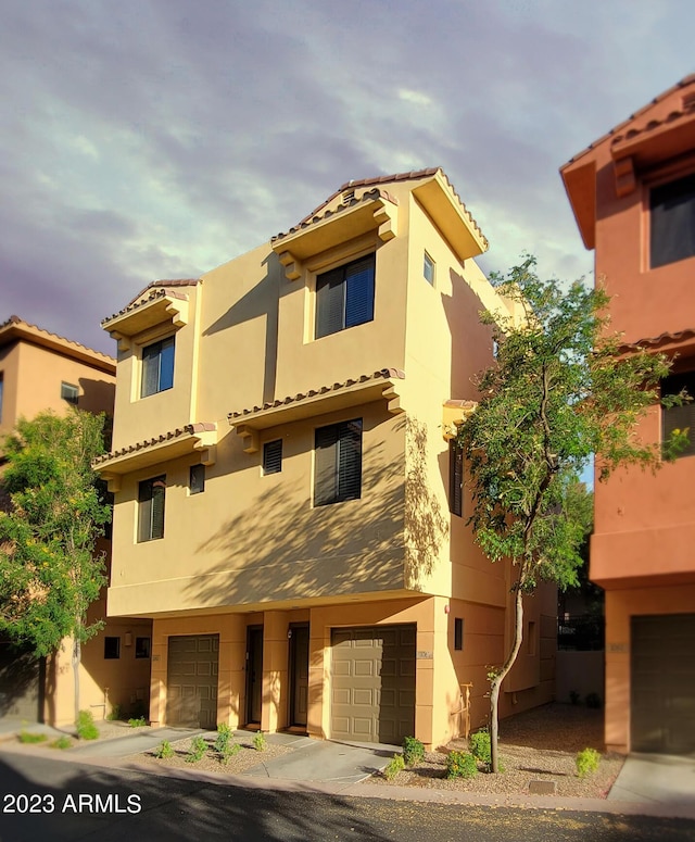 9551 E Redfield Rd Unit 1061, Scottsdale, AZ 85260 - view of front facade featuring a garage, stucco siding, and a tiled roof