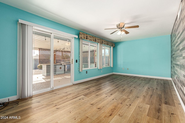 unfurnished room featuring plenty of natural light, light hardwood / wood-style floors, and ceiling fan