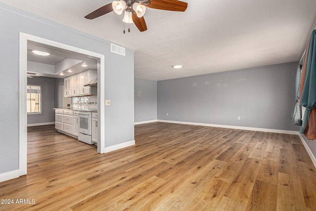 unfurnished living room with light hardwood / wood-style flooring and ceiling fan