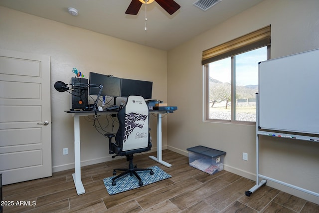 home office featuring baseboards, ceiling fan, visible vents, and wood finish floors