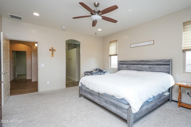 bedroom with multiple windows, visible vents, and arched walkways