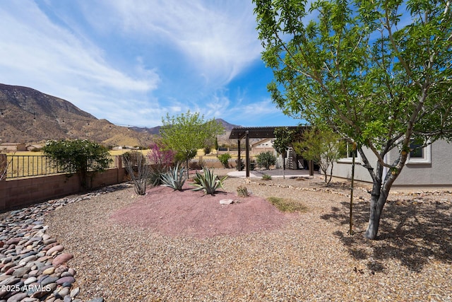 view of yard featuring a patio, a mountain view, a fenced backyard, and a pergola