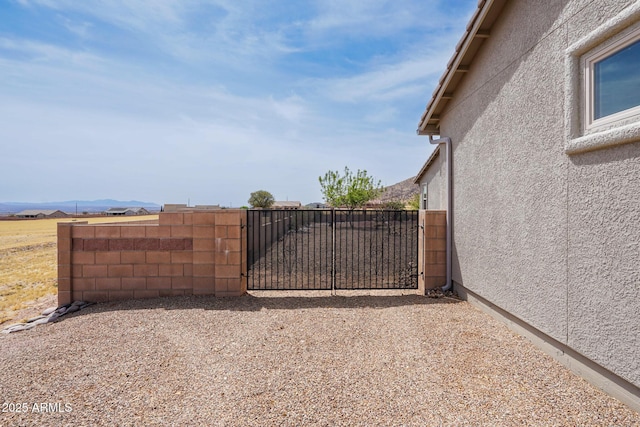 view of gate with fence