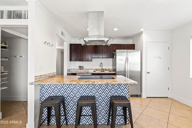 8315 E Devonshire Ave, Scottsdale, AZ 85251 - kitchen with freestanding refrigerator, light tile patterned flooring, a kitchen bar, a peninsula, and dark brown cabinets