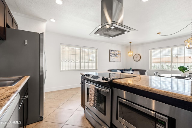 8315 E Devonshire Ave, Scottsdale, AZ 85251 - kitchen with stainless steel appliances, island exhaust hood, crown molding, light stone counters, and light tile patterned floors