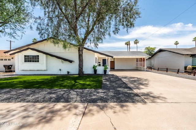 8315 E Devonshire Ave, Scottsdale, AZ 85251 - ranch-style home featuring concrete driveway, a carport, and board and batten siding