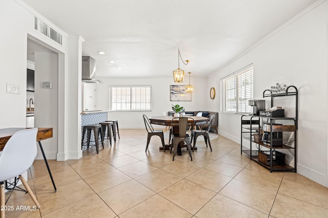 8315 E Devonshire Ave, Scottsdale, AZ 85251 - dining space with healthy amount of natural light, baseboards, light tile patterned floors, ornamental molding, and recessed lighting