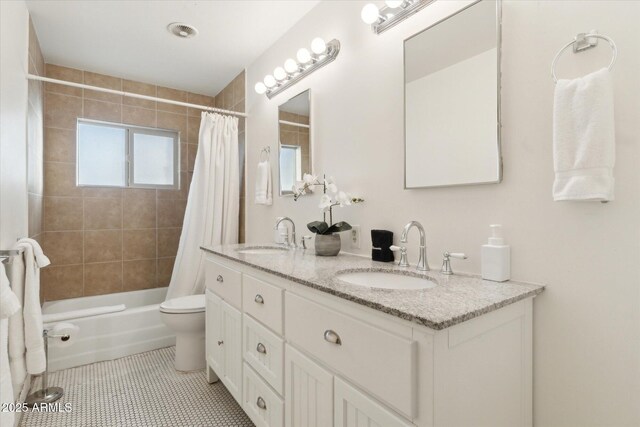 bathroom featuring tile patterned flooring, toilet, shower / bathtub combination with curtain, and a sink