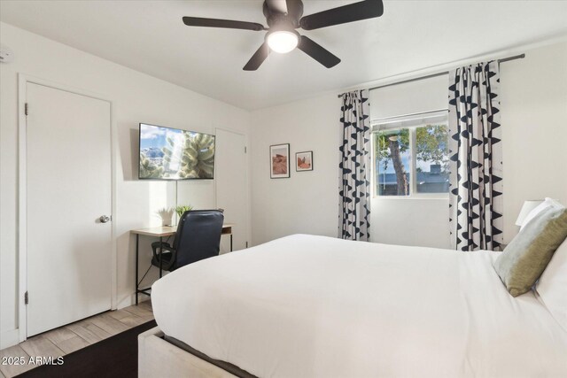 bedroom with ceiling fan and light wood-style floors