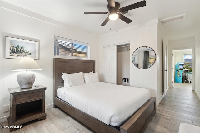 bedroom with light wood-style floors, a closet, and ceiling fan