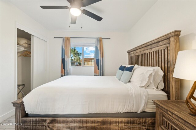 bedroom featuring a closet, baseboards, and ceiling fan