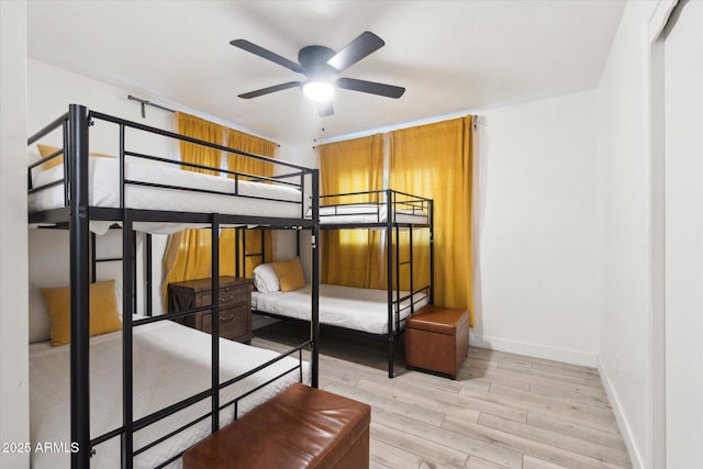 bedroom featuring baseboards and light wood-type flooring