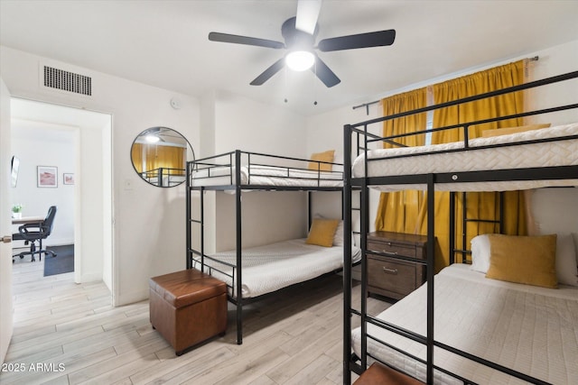 bedroom with visible vents, baseboards, and light wood-style flooring