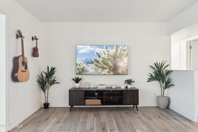 interior space featuring baseboards and wood finished floors