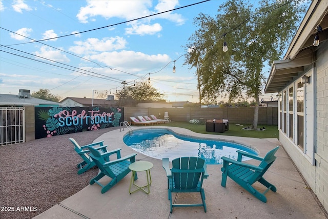 view of swimming pool with a patio, fence, and a fenced in pool