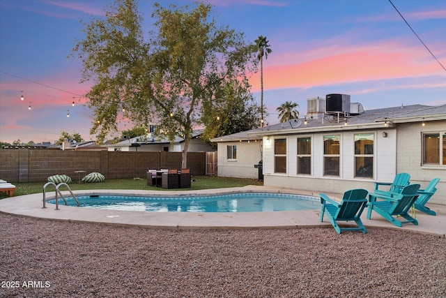 view of swimming pool with a patio, cooling unit, a fenced backyard, and a fenced in pool