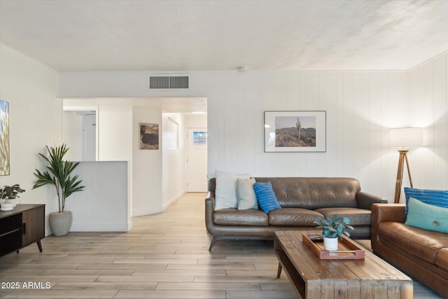 living room featuring visible vents and light wood-type flooring