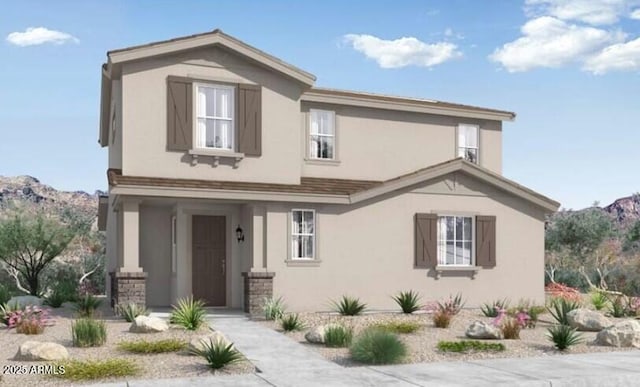 traditional-style house featuring stucco siding