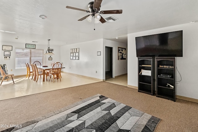 carpeted living room featuring ceiling fan