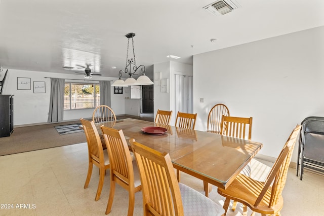 dining room featuring ceiling fan with notable chandelier