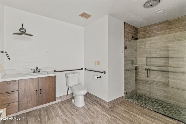 bathroom with vanity, toilet, and an enclosed shower