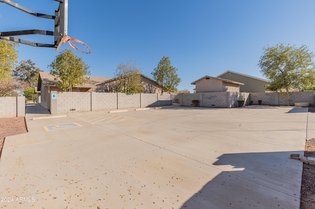 exterior space featuring basketball hoop