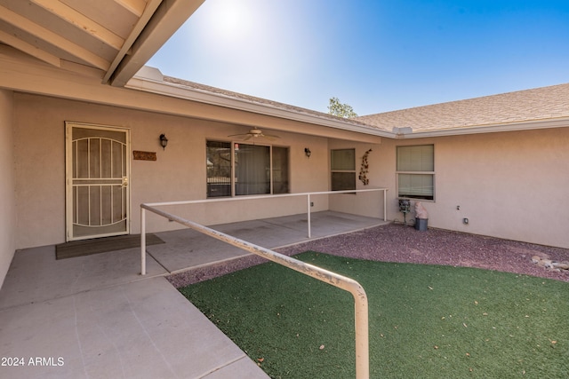 view of exterior entry featuring a patio area and ceiling fan