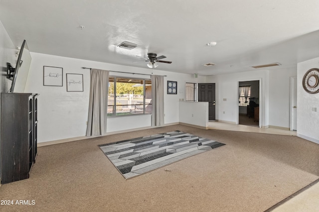 carpeted living room featuring ceiling fan