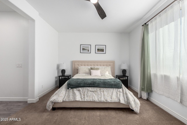 carpeted bedroom featuring ceiling fan and multiple windows