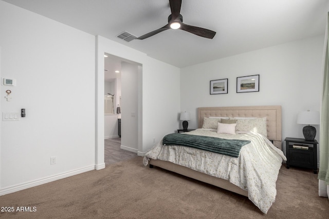 carpeted bedroom with ceiling fan and connected bathroom