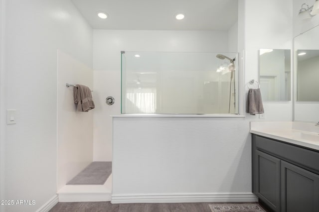 bathroom with vanity, a shower, and hardwood / wood-style floors