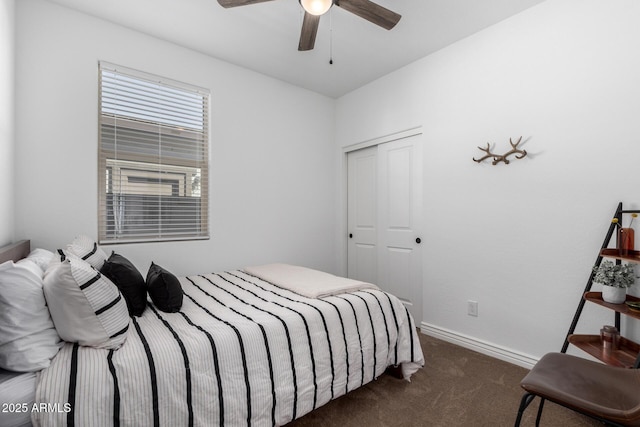 carpeted bedroom featuring ceiling fan and a closet