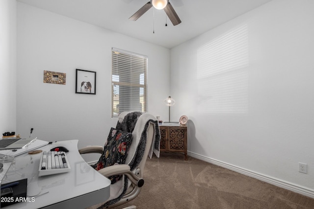 carpeted office featuring ceiling fan