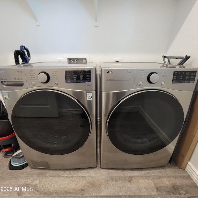 clothes washing area featuring independent washer and dryer