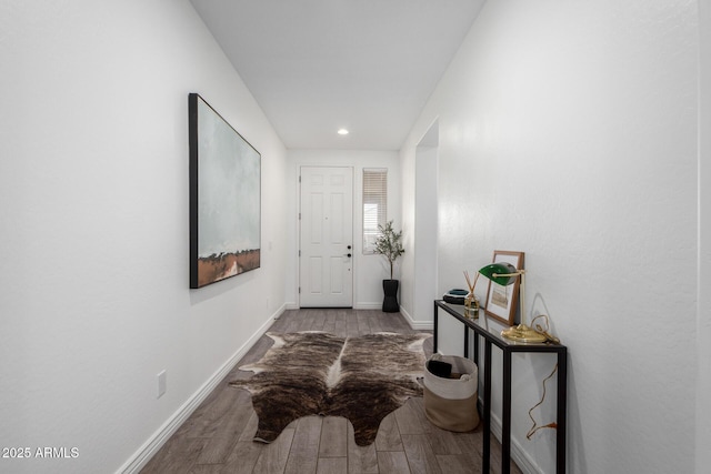 hallway with hardwood / wood-style flooring