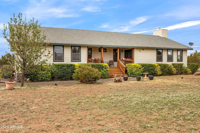 8870 Happy Trl, Show Low, AZ 85901 - ranch-style house featuring a porch, a front lawn, a chimney, and a shingled roof