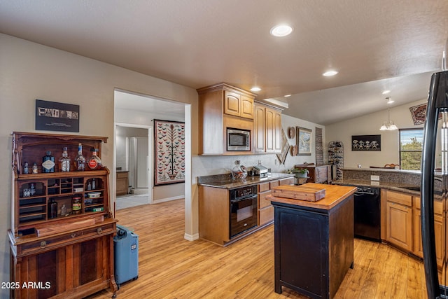 8870 Happy Trl, Show Low, AZ 85901 - kitchen featuring black appliances, light wood-style floors, a center island, lofted ceiling, and butcher block counters