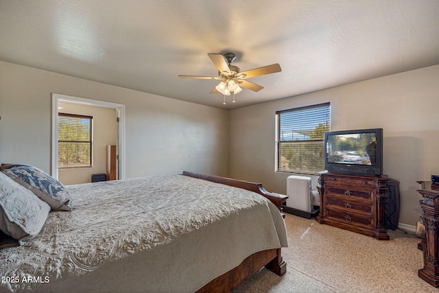 8870 Happy Trl, Show Low, AZ 85901 - bedroom featuring multiple windows, light colored carpet, and a ceiling fan