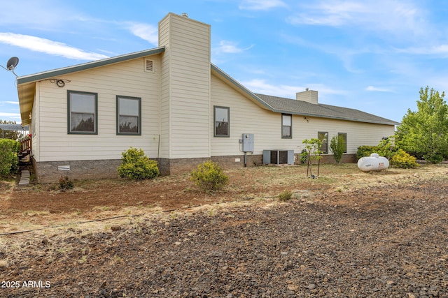 8870 Happy Trl, Show Low, AZ 85901 - view of home's exterior with a chimney and a central air condition unit