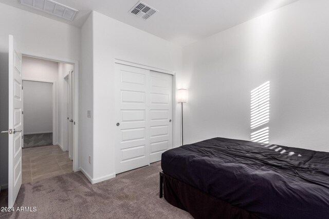 bedroom featuring carpet and a closet